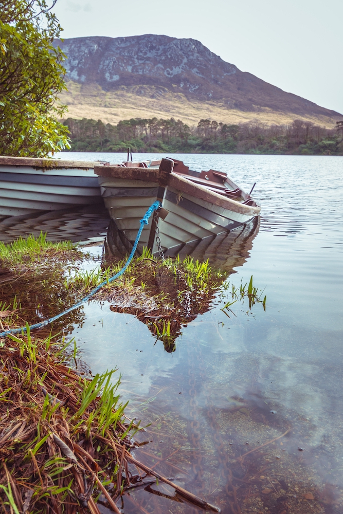 Rowboats anchored in a lake in Connemara, Ireland
